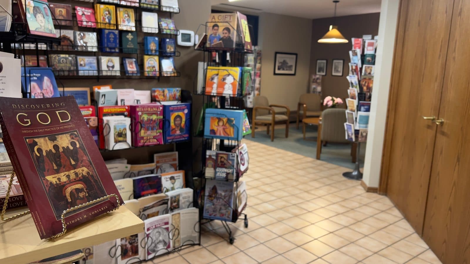 Welcoming church store interior with religious books, gift displays, and a quiet seating area