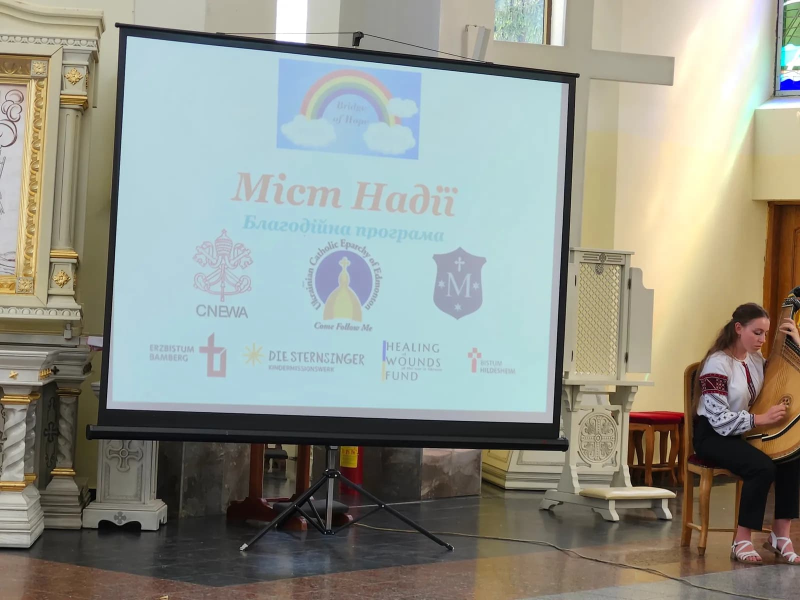 A young woman plays the bandura during a presentation about the "Bridge of Hope" program.